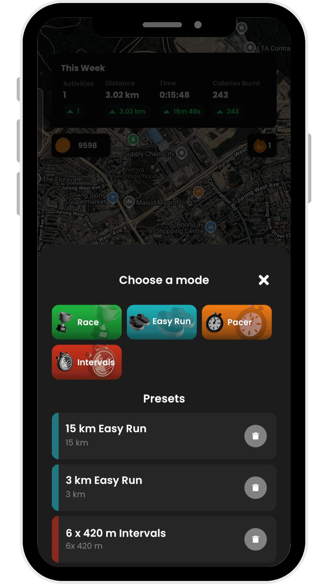 RunAI app start screen with a satellite map of Jurong West, Singapore in the background. A weekly summary panel shows 1 activity, 3.02 km distance, 15:48 time, and 243 calories burnt. Below, a 'Choose a mode' modal presents four run modes as coloured buttons: Race (green), Easy Run (teal), Pacer (orange), and Intervals (red). Underneath are saved presets including '15 km Easy Run', '3 km Easy Run', and '6 x 420 m Intervals', each with a delete button.